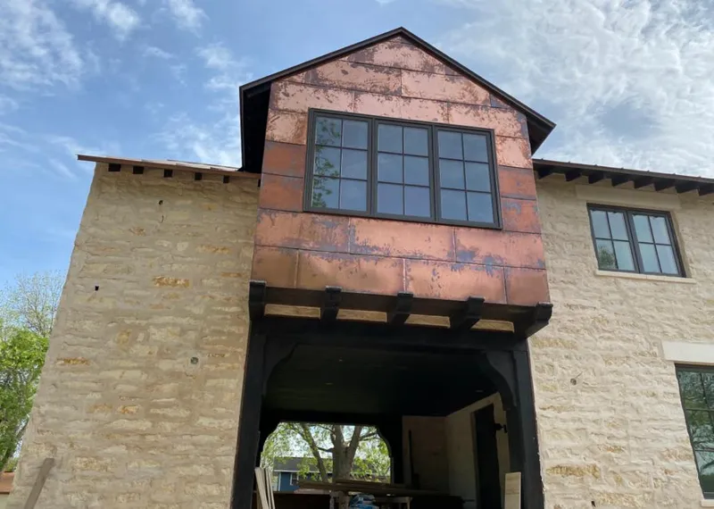 Copper metal panel facade on a stone building for Skylight Installation in Delavan